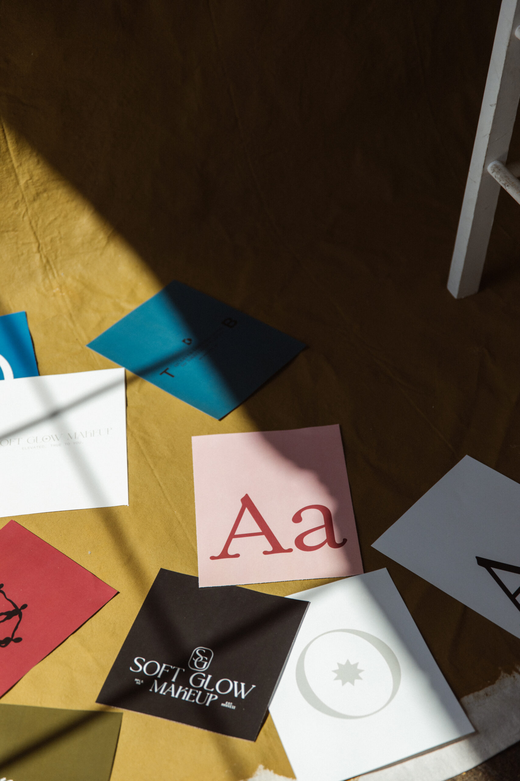 Print outs of logos and brand color palettes from luxury branding portfolio